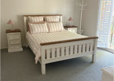 master bed with pink stripes sheets