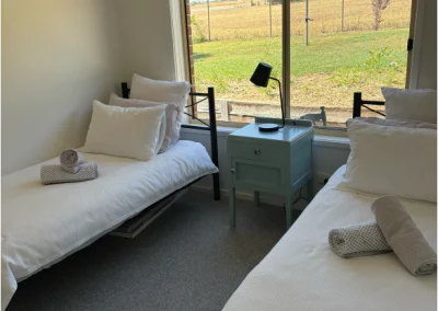 other side of the room - two single beds with view of garden